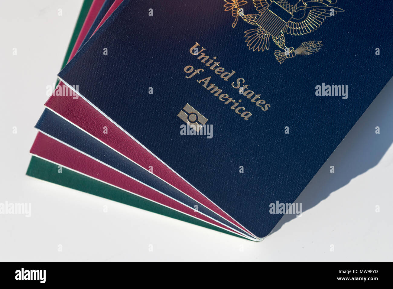 Dark blue US Passport Alongside EU Style Red and Green Passports Stock