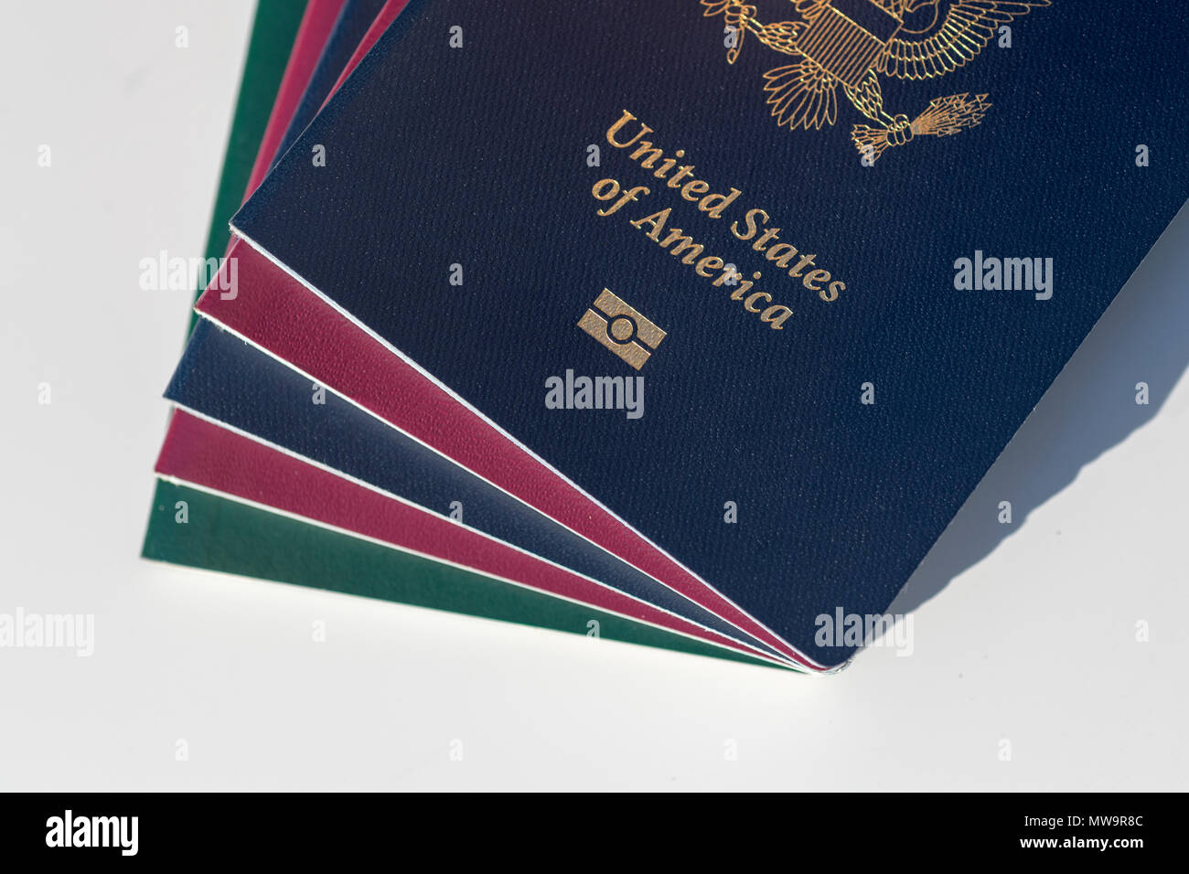 Dark blue US Passport Alongside EU Style Red and Green Passports Stock
