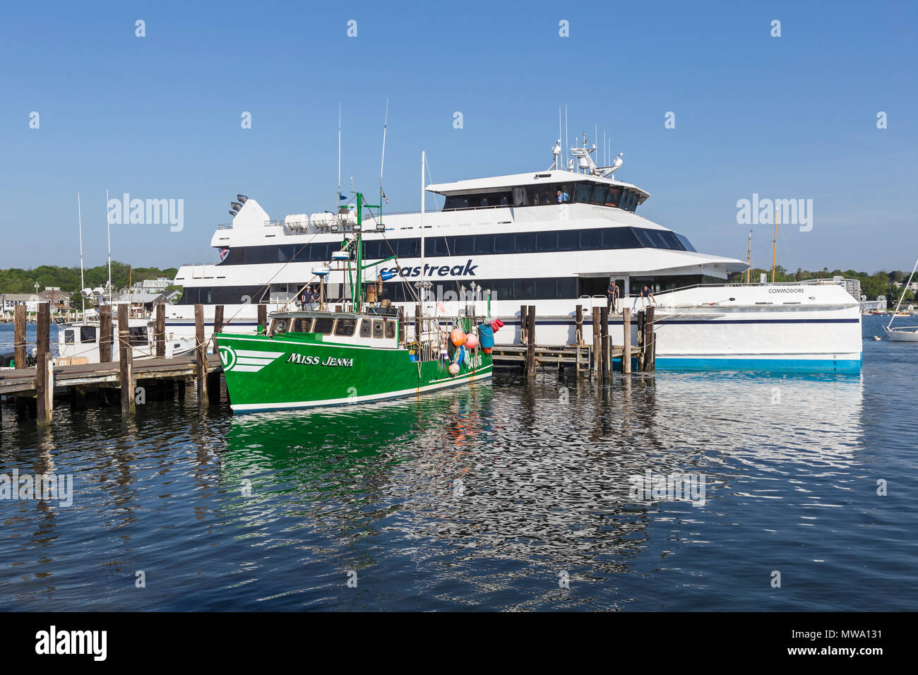 Commercial fishing vessel 'Miss Jenna' docked next to a Seastreak ferry in Vineyard Haven harbor, in Tisbury, Massachusetts on Martha's Vineyard. Stock Photo