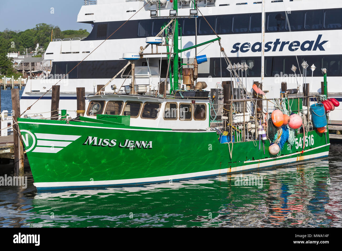 Commercial fishing vessel 'Miss Jenna' docked next to a Seastreak ferry in Vineyard Haven harbor, in Tisbury, Massachusetts on Martha's Vineyard. Stock Photo