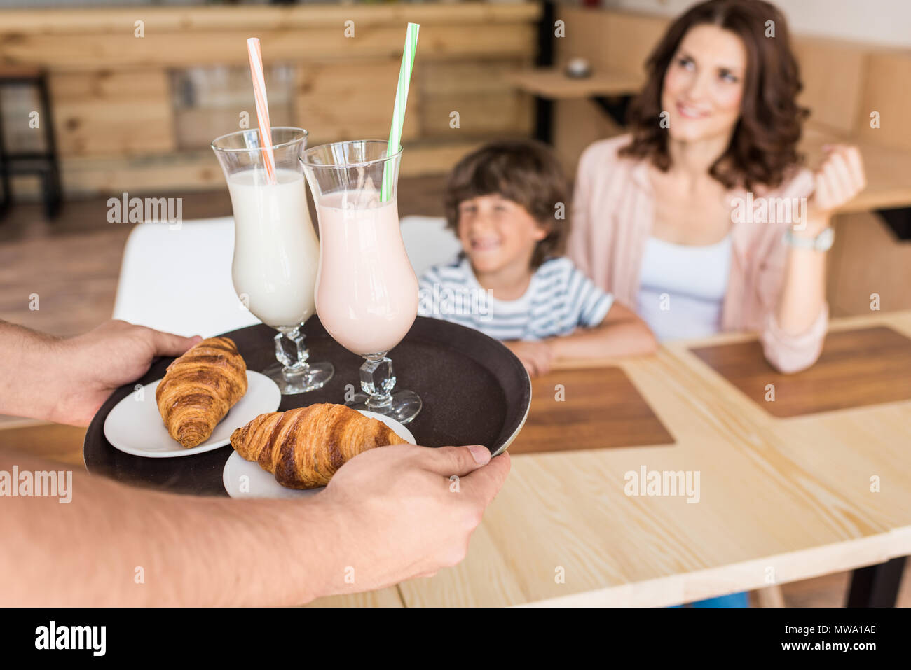 happy mother and son waiting for order in cafe Stock Photo