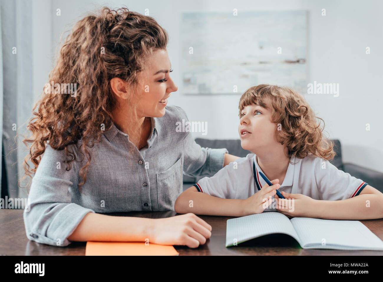 beautiful young mother and son doing homework together Stock Photo - Alamy