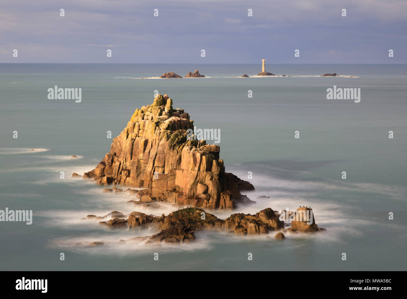 The Armed Knight and Longships Lighthouse at Land's End Stock Photo