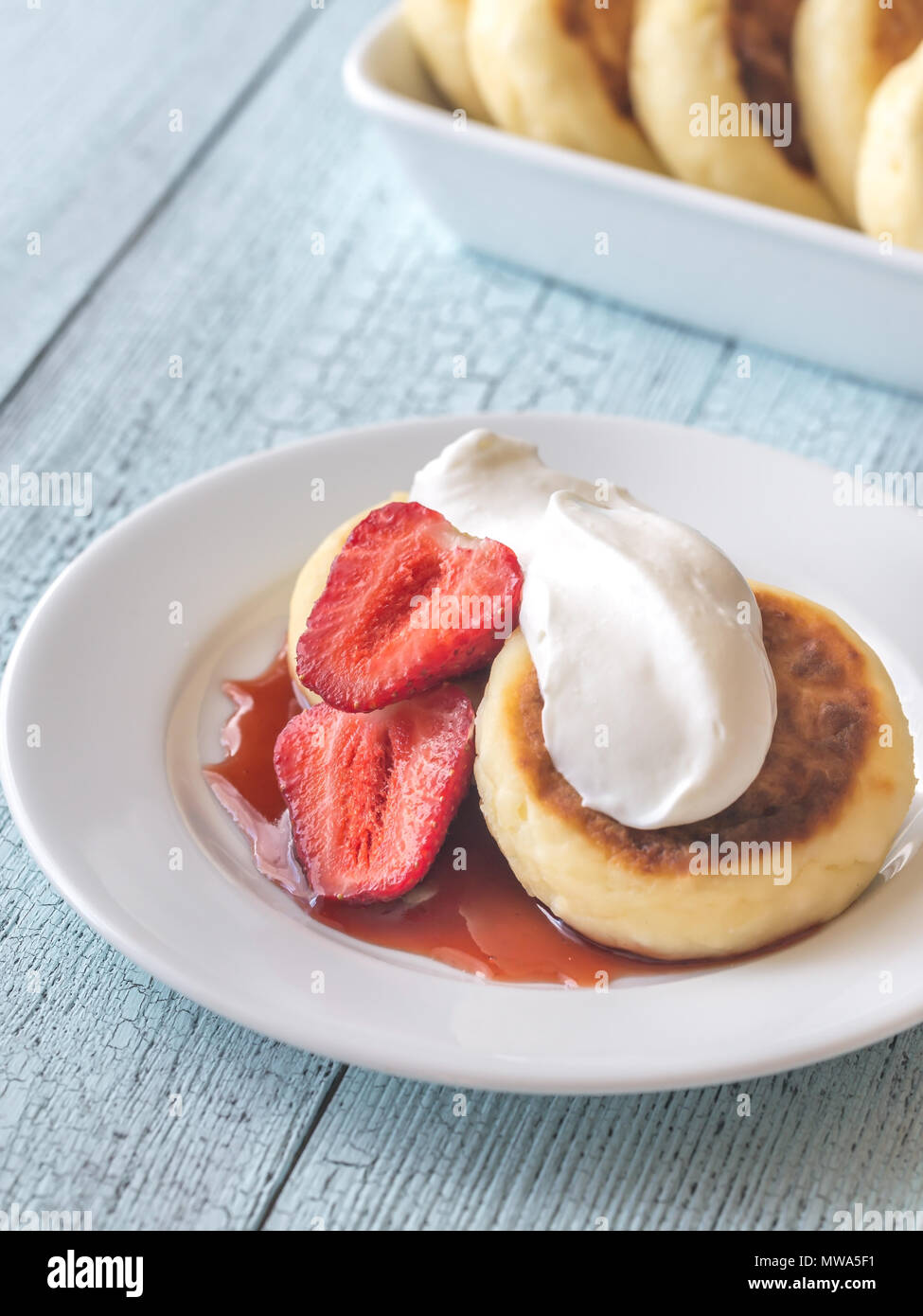 Cottage Cheese Patties With Whipped Cream And Berry Syrup Stock
