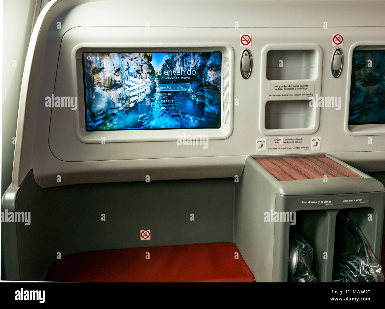 Business Class seats LATAM airlines Dreamliner 787 flying from Easter Island to Santiago, with welcome video console in flight entertainment Stock Photo