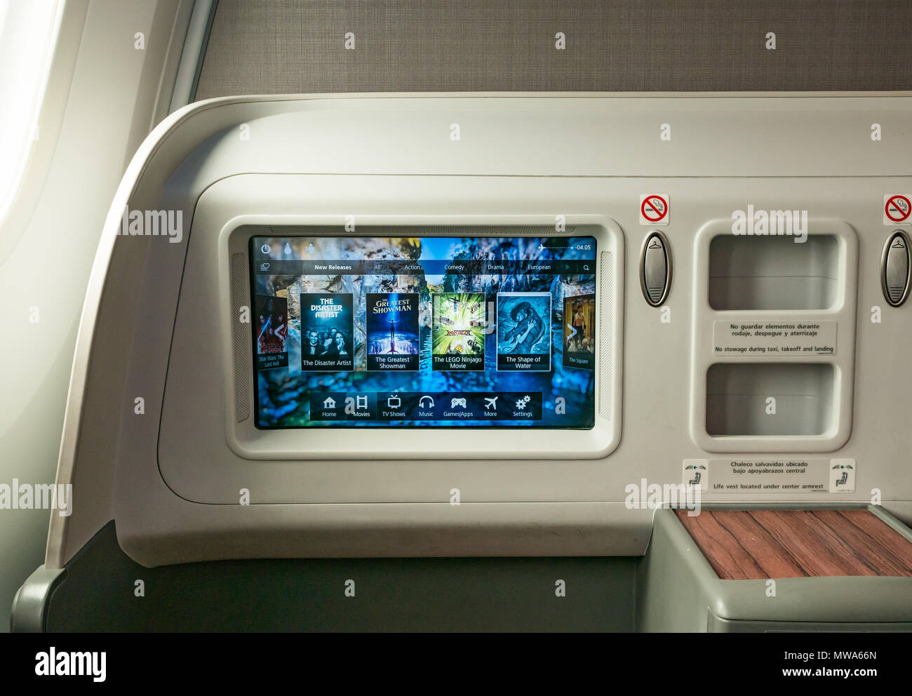 Business Class seats LATAM airlines Dreamliner 787 flying from Easter Island to Santiago, with video console showing in flight entertainment movies Stock Photo