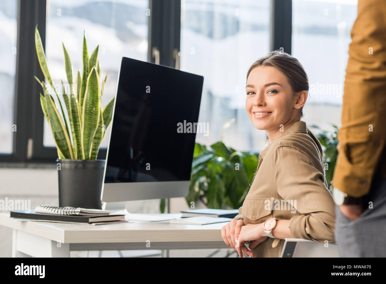 happy young manageress sitting at workplace Stock Photo