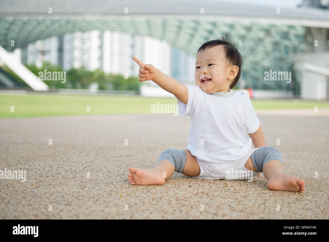 Asian baby boy crawling in park Stock Photo