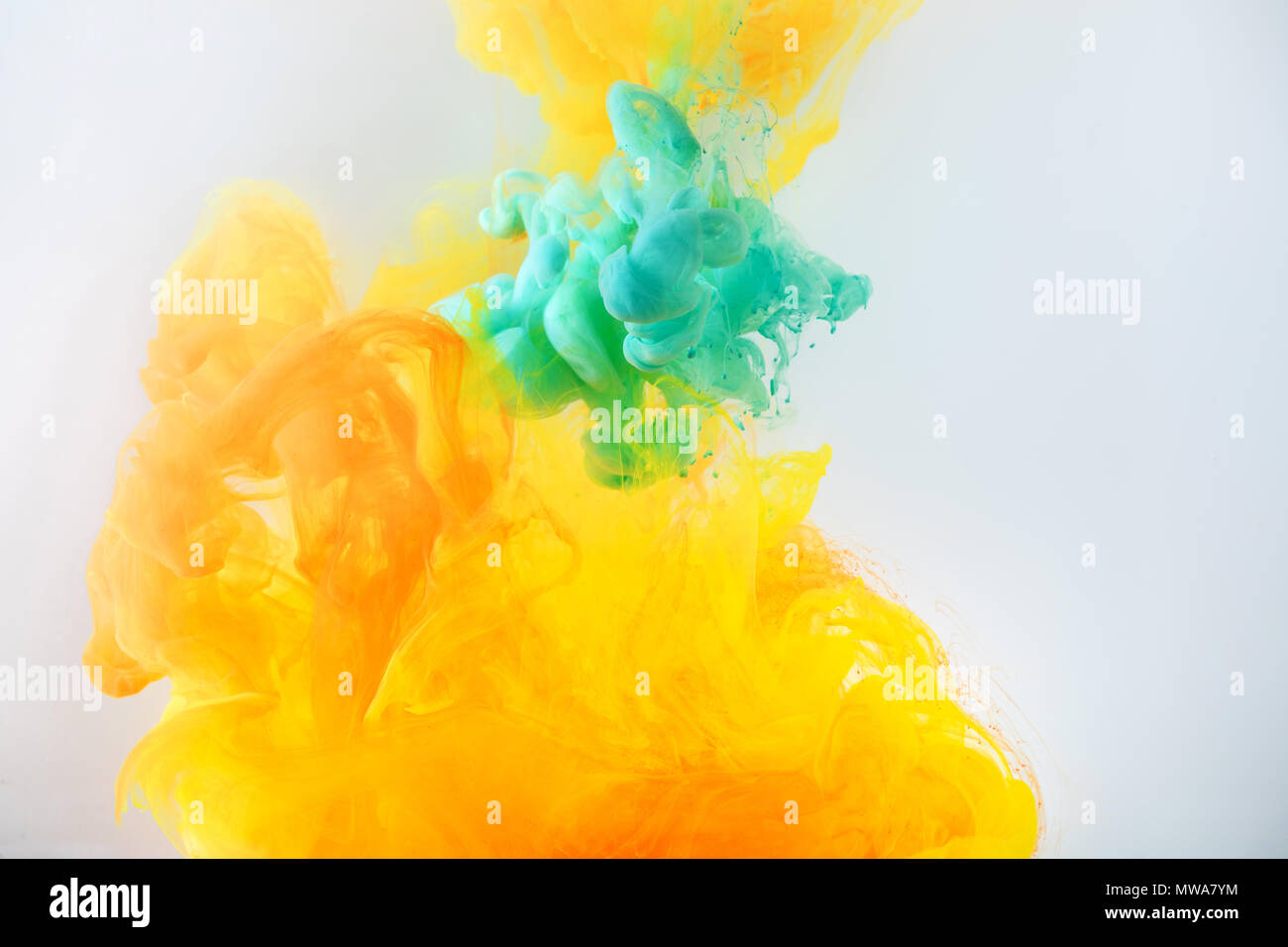 creative background with turquoise and orange paint flowing in water ...