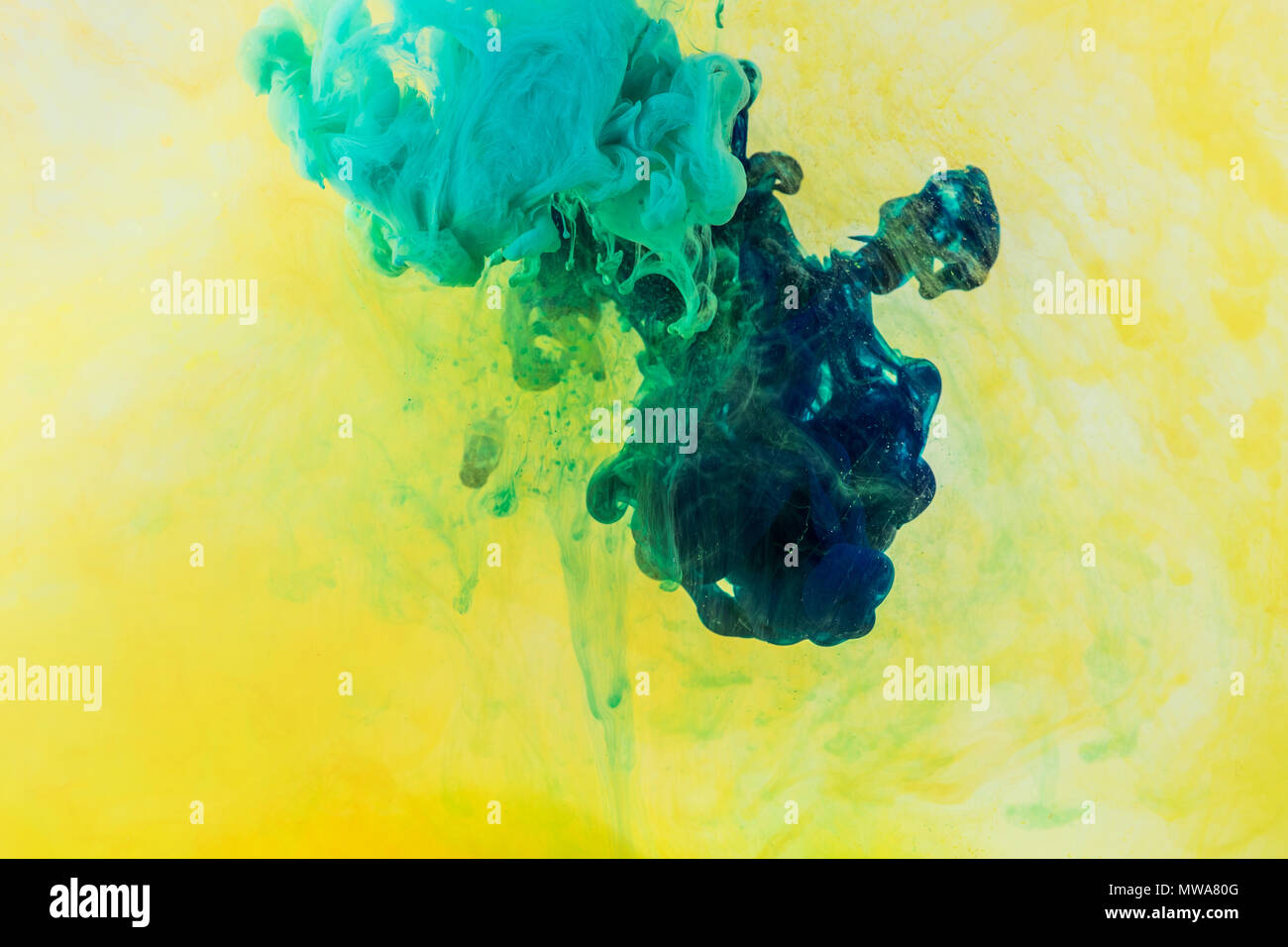 background with green and turquoise paint flowing in yellow water Stock ...