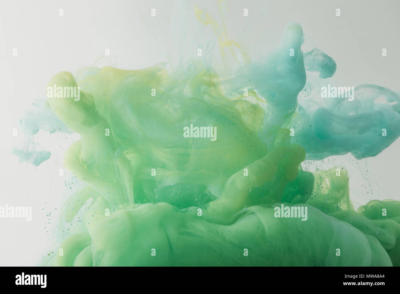 light texture with flowing turquoise and green paint in water, isolated ...