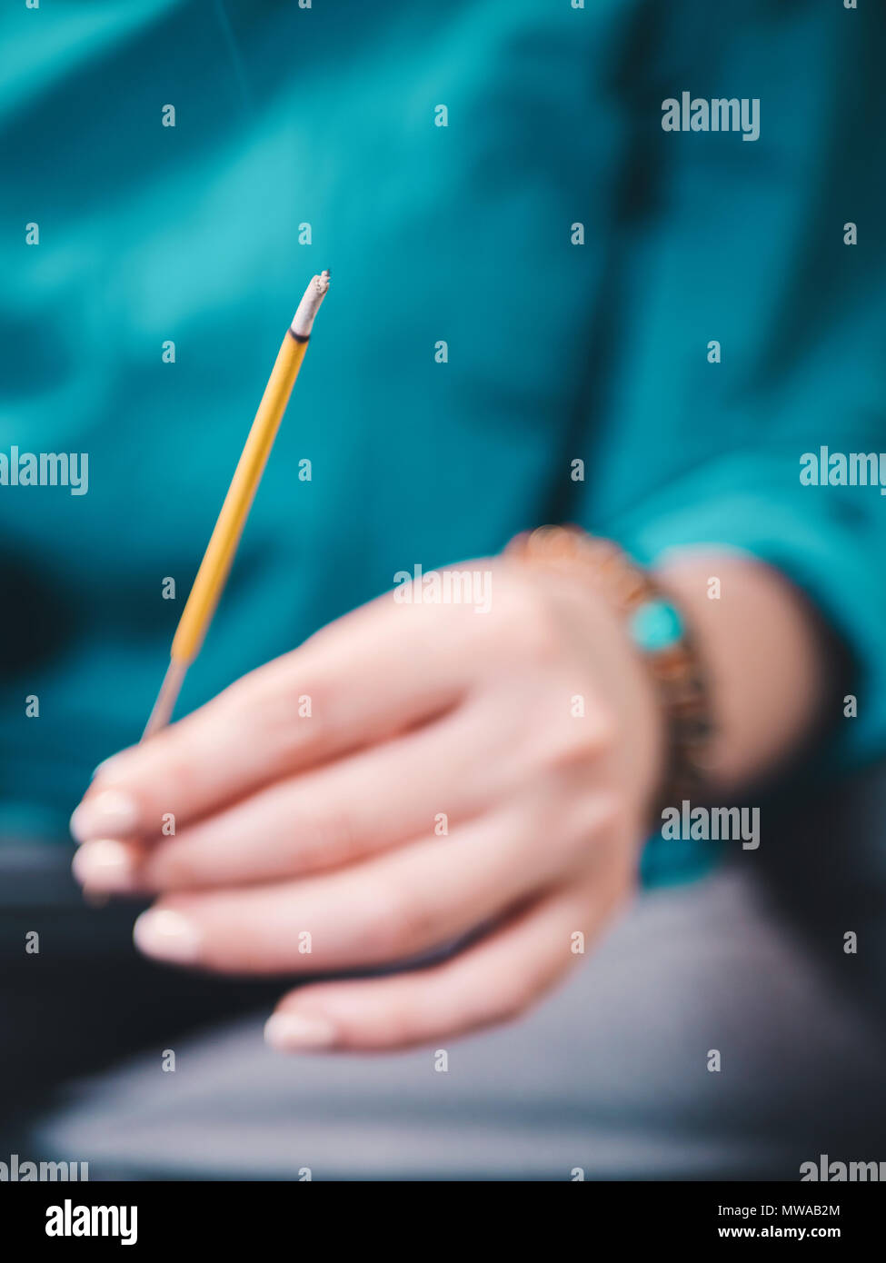 Incense sticks in woman hand. Use for pray respect to the Buddha in
