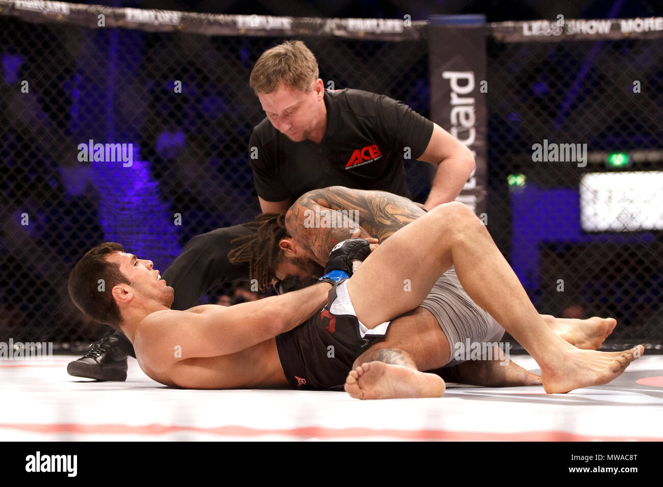 MMA referee Viktor Korneev steps in to stop a fight between Aurel Pirtea and Saul Rogers at ACB 54 in Manchester, UK. Pirtea won in the second round by submission. Absolute Championship Berkut, Mixed Martial Arts, MMA fight. Stock Photo