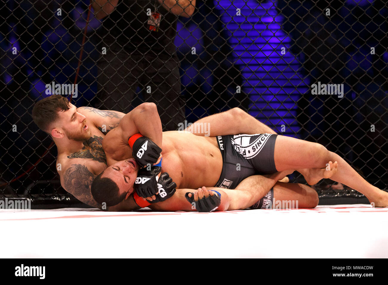 Eden Newton (left) with Azi Thomas in a submission hold at ACB 54 in Manchester, UK. Absolute Championship Berkut, Mixed Martial Arts, MMA fight. Stock Photo