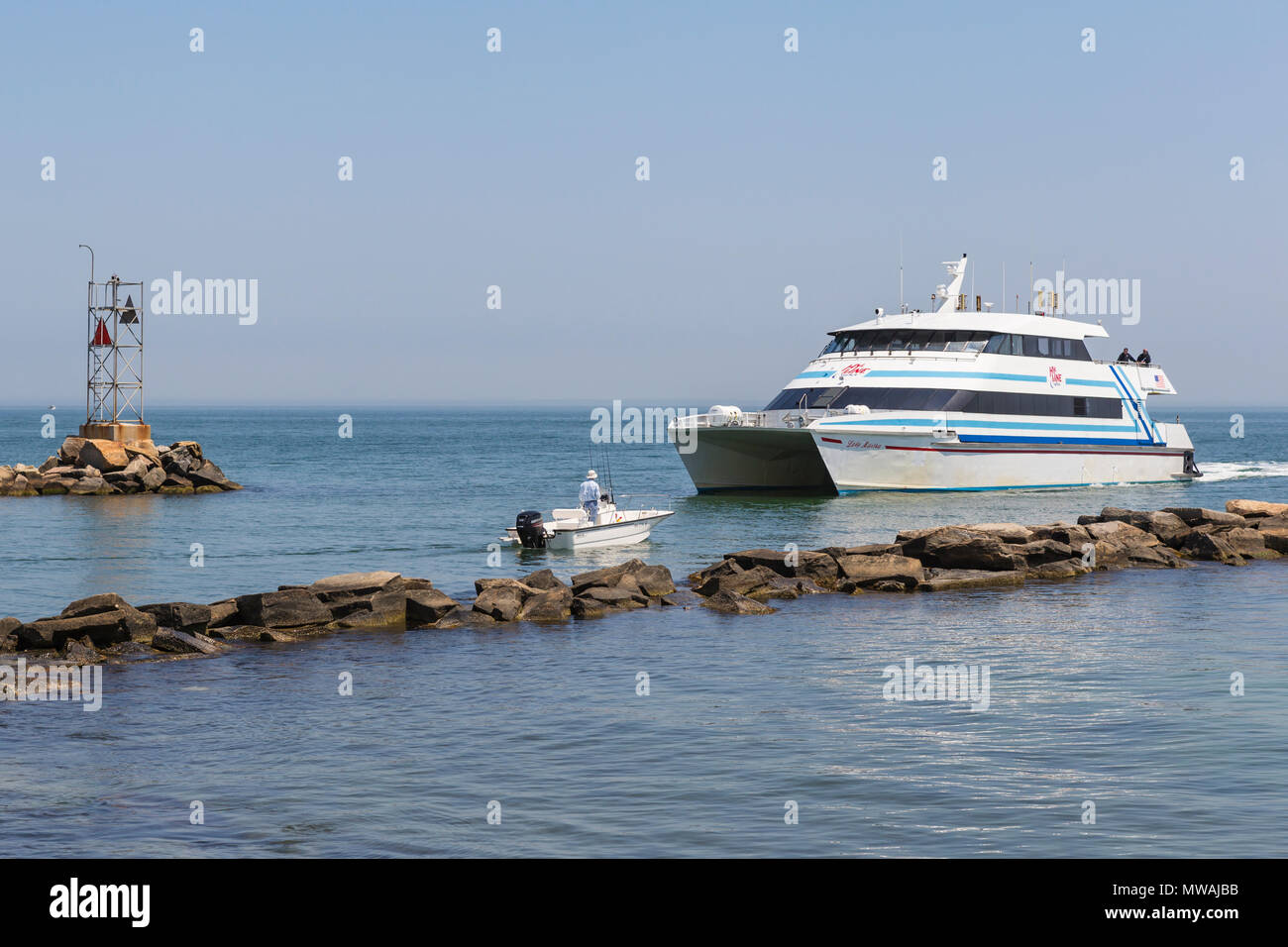 A Hy-Line Cruises high-speed catamaran ferry from Hyannis to Martha's Vineyard enters the harbor in Oak Bluffs, Massachusetts. Stock Photo