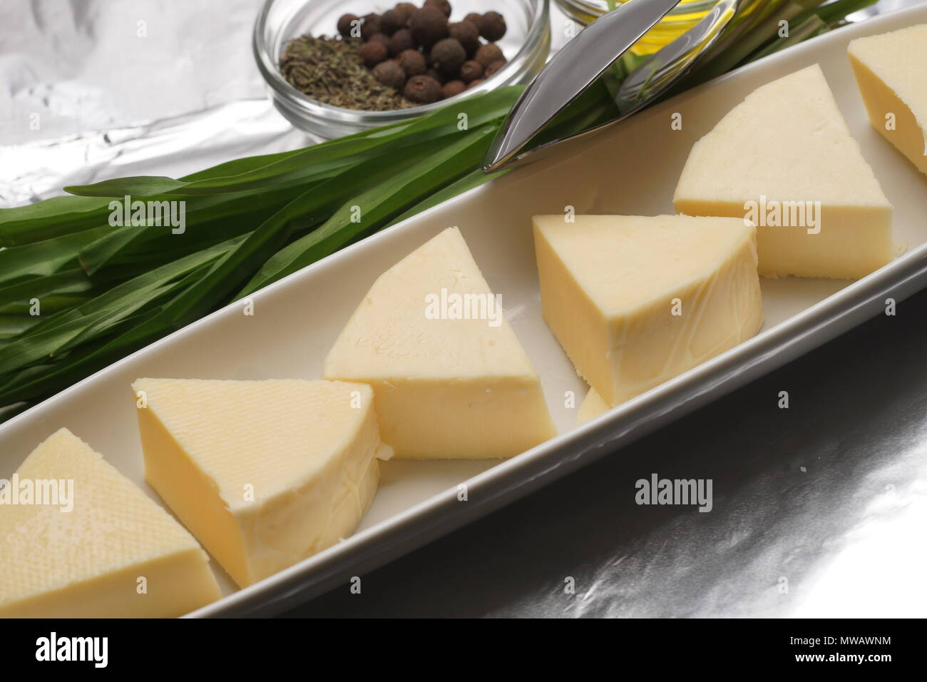 Cheese slices on a plate Stock Photo