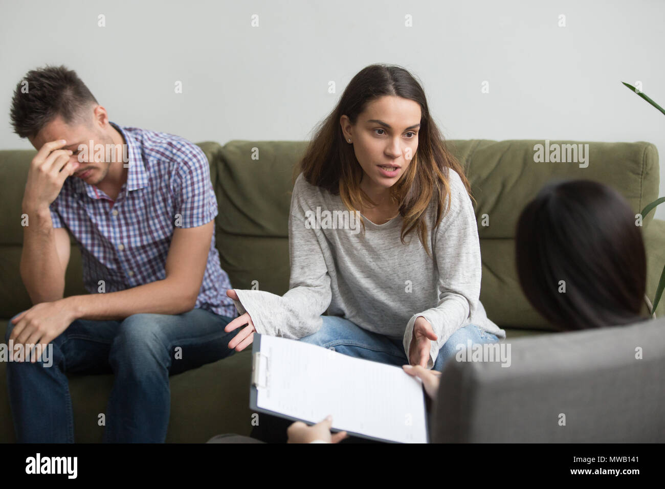 Unhappy frustrated woman sharing problems with counselor, couple Stock Photo
