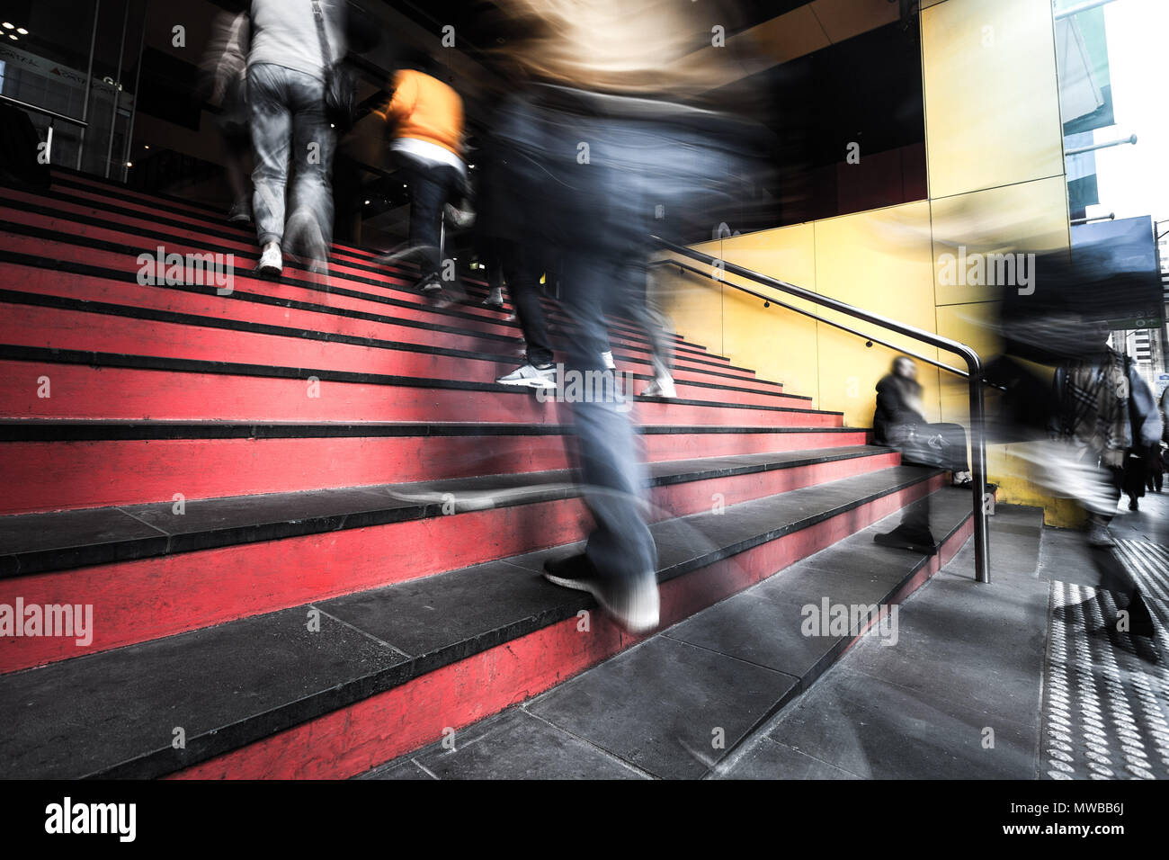 Blurred motion of people walking up the stairs into a building in melbourne, Australia Stock Photo