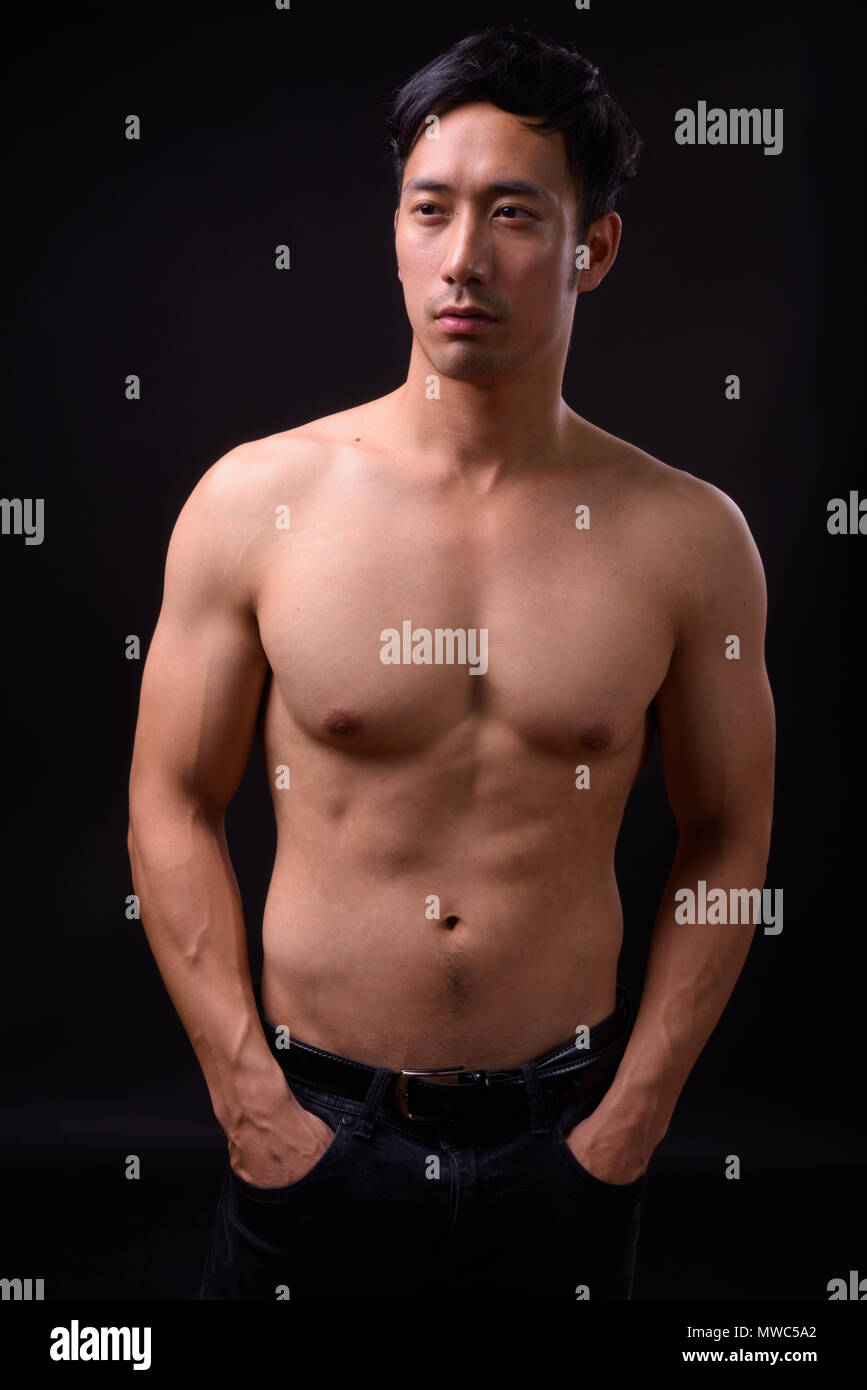 Young Handsome Asian Man Shirtless Against Black Background Stock Photo Alamy