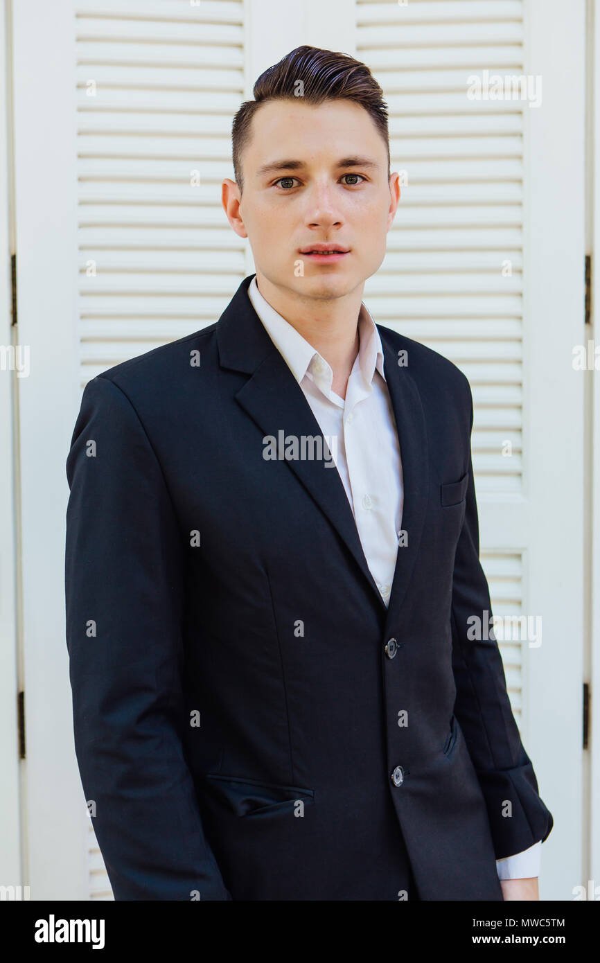 Portrait of handsome man in black suit on the white background Stock ...