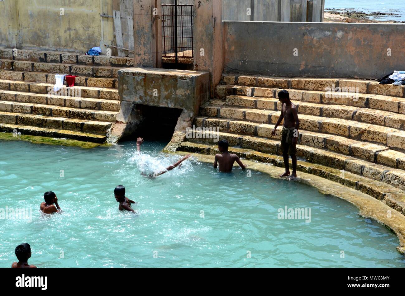 Keerimalai fresh water spring tank by ocean water and Tamil Hindu temple Jaffna Sri Lanka Stock Photo