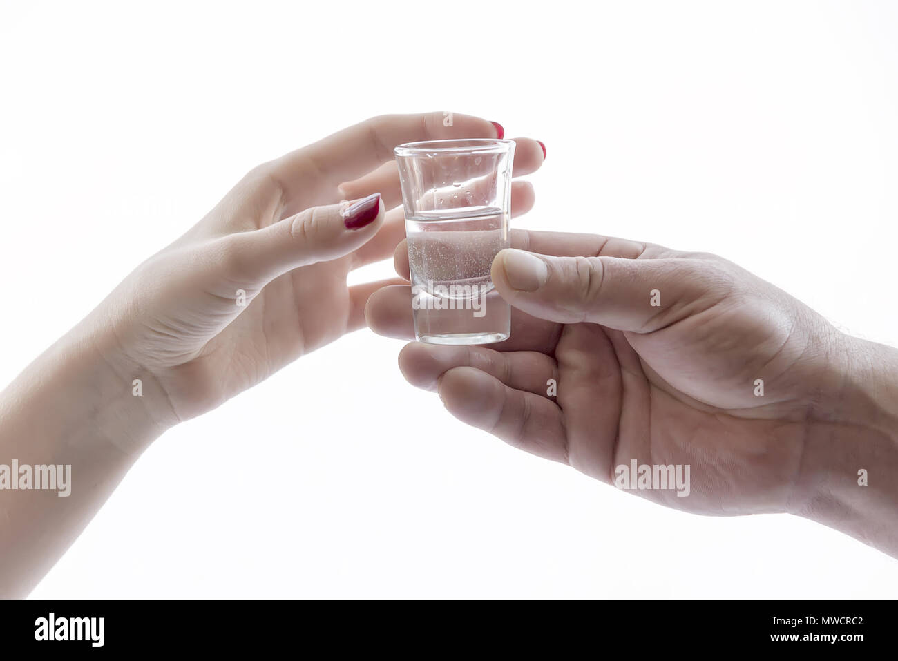 men's and women's hand holding glasses of alcohol Stock Photo