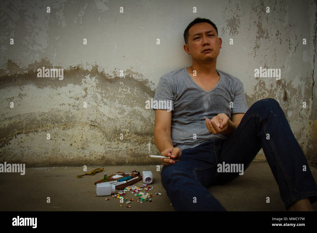 Asia man smoking cigarette is sad and pain by drug addiction problem. World no tobacco day, 31 may. Stock Photo