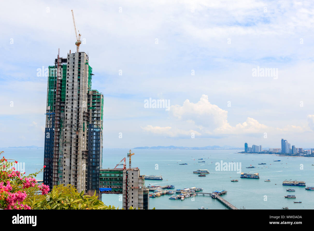 PATTAYA - AUGUST 23, 2014: The new building site name is "Water Front Suites &a mp ; Residence Pattaya" , Building Obscured the view Pratamnak Hill. A Stock Photo