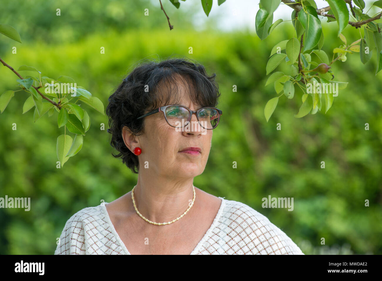 a portrait of a beautiful mature woman in the garden Stock Photo - Alamy