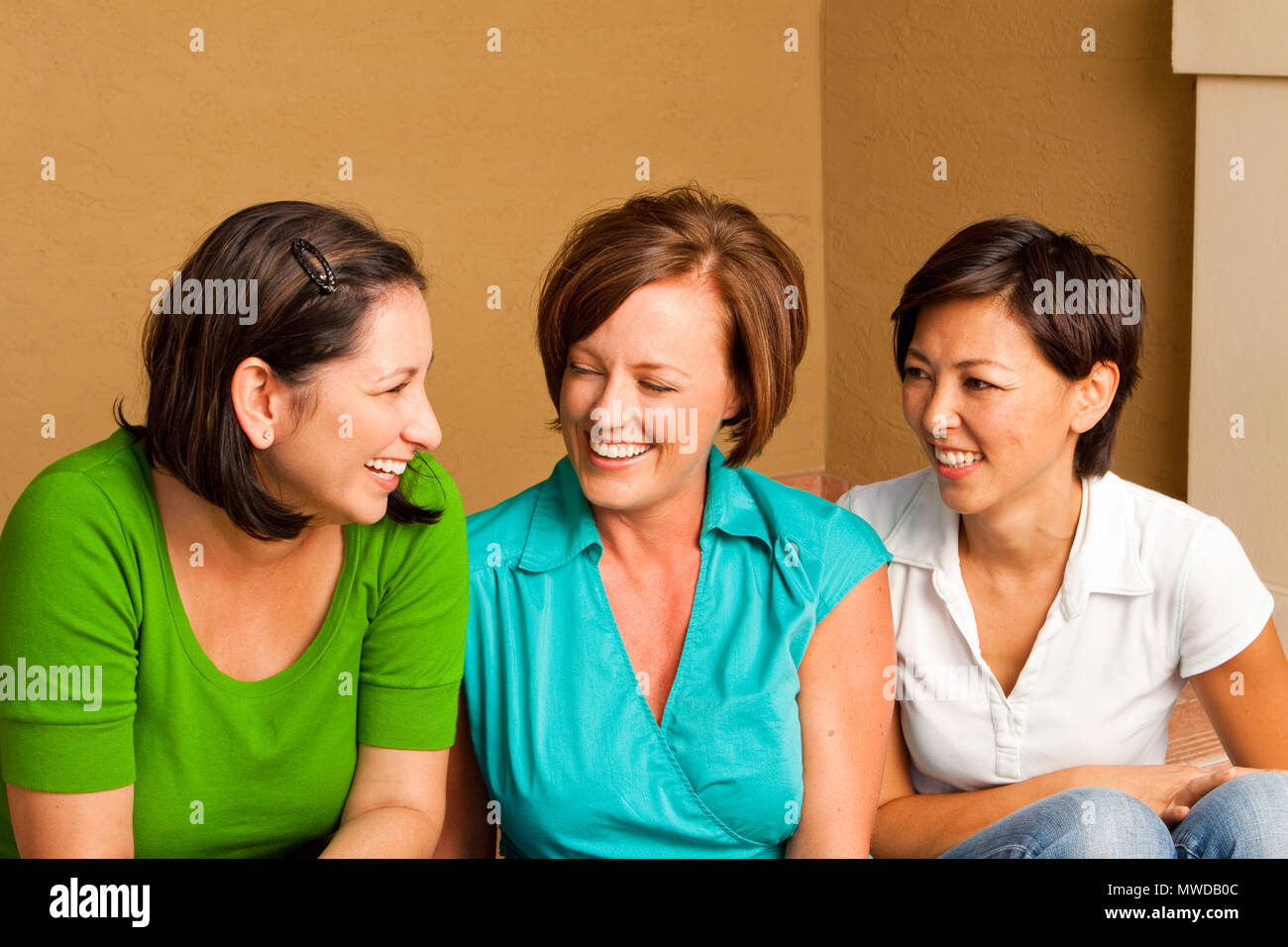 Diverse group of friends talking and laughing. Stock Photo