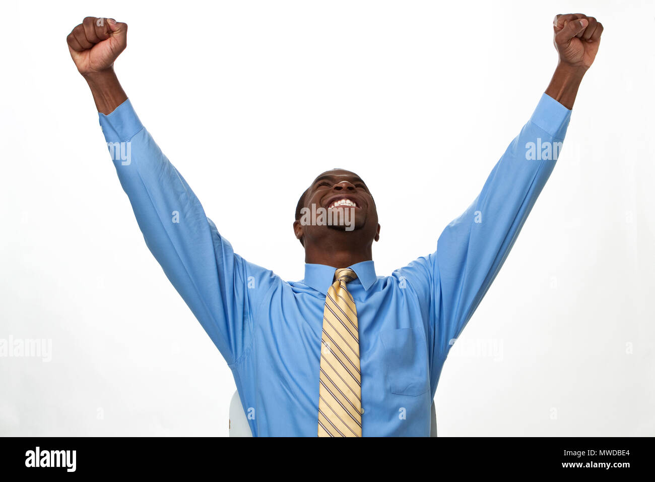 Excited African man shouting with his hands in the air. Stock Photo