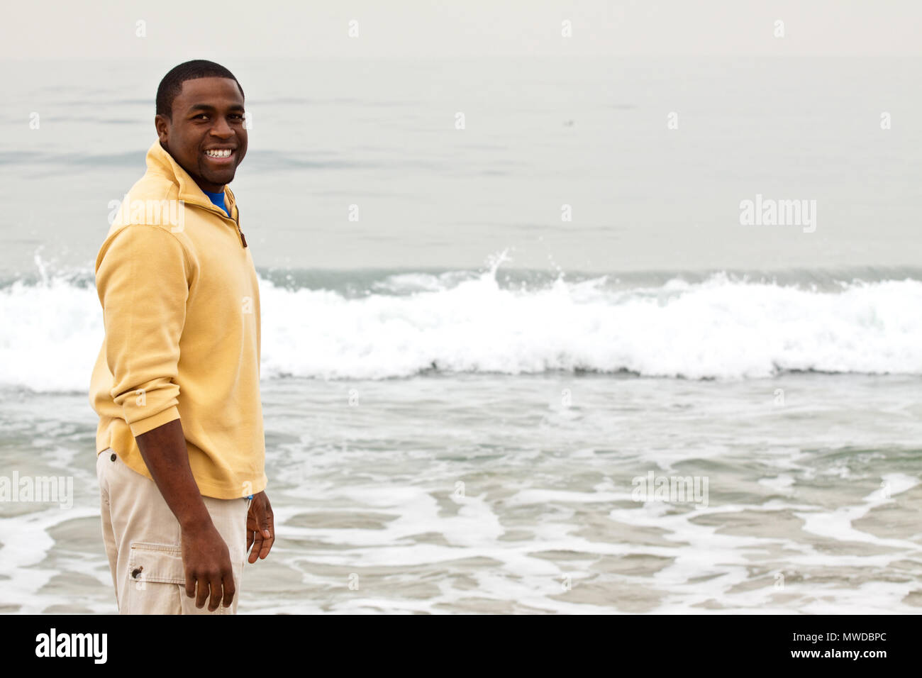 African American man walking on the beach Stock Photo - Alamy