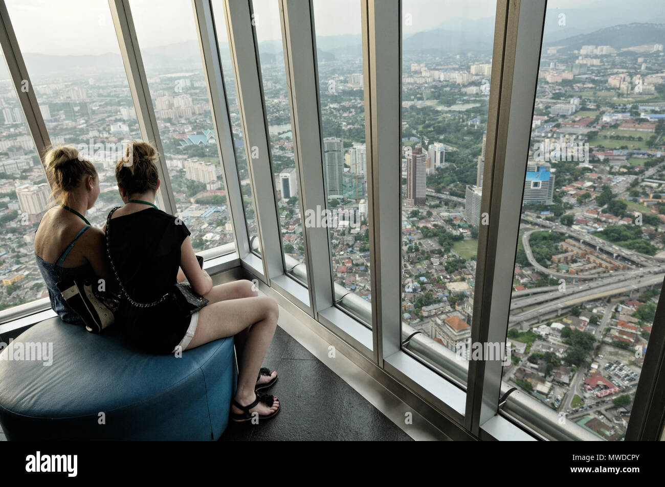 Two Young Women On The 86th Floor Of Petronas Twin Towers In Kuala