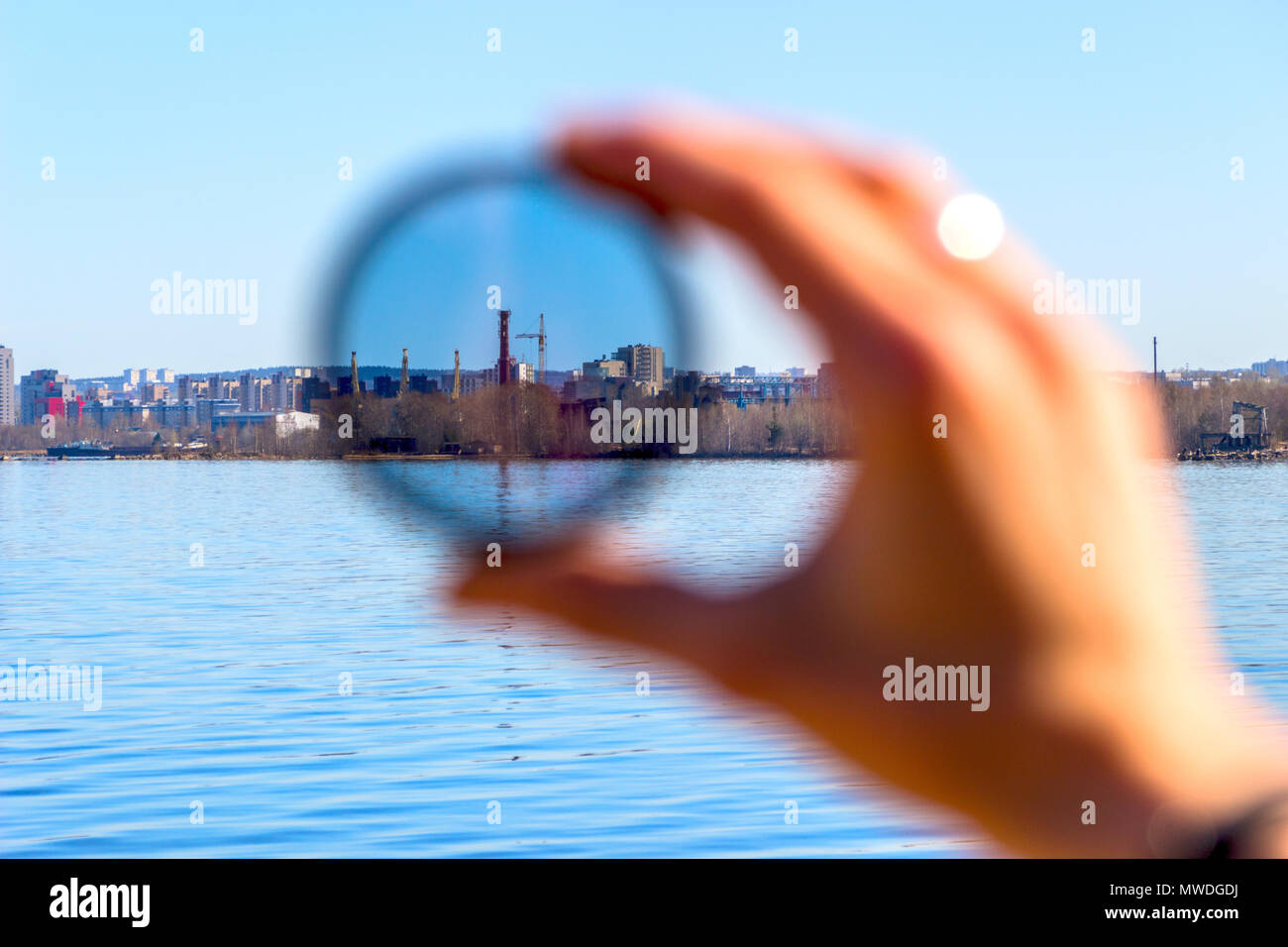 City through a polarizing filter in the female hand Stock Photo