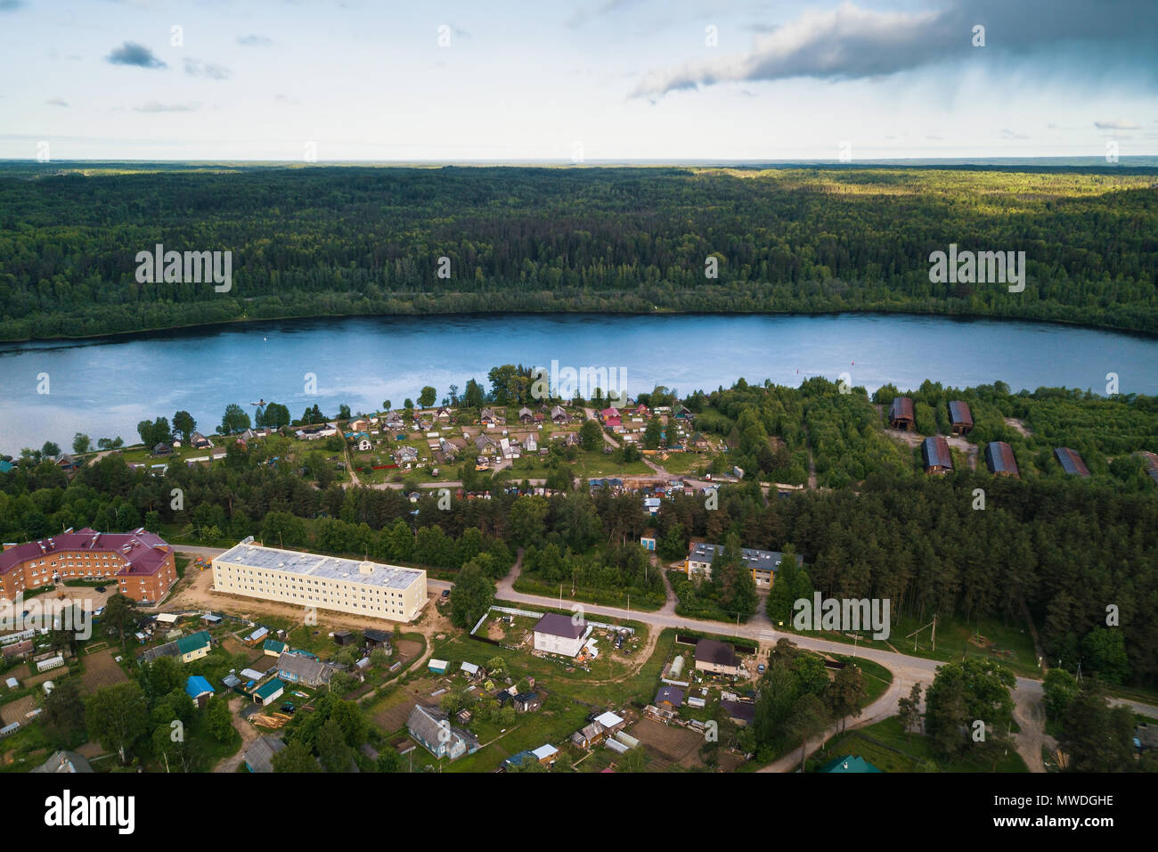 Svir river and summer green forests of Leningrad region, Russia. Bird's eye view of an urban-type settlement. Stock Photo
