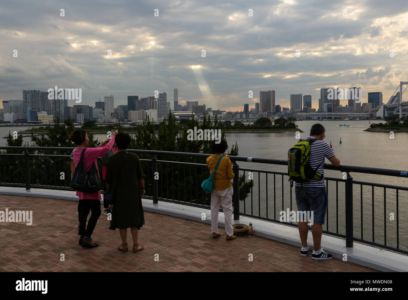 Odaiba Tokyo 1 June 18 Calm Seascape With Sun Rays Through Dark Clouds Before Sunset Over Odaiba Tokyo 1 June 18 Calm Seascape With Sun Rays Through Dark Clouds Before Sunset Over