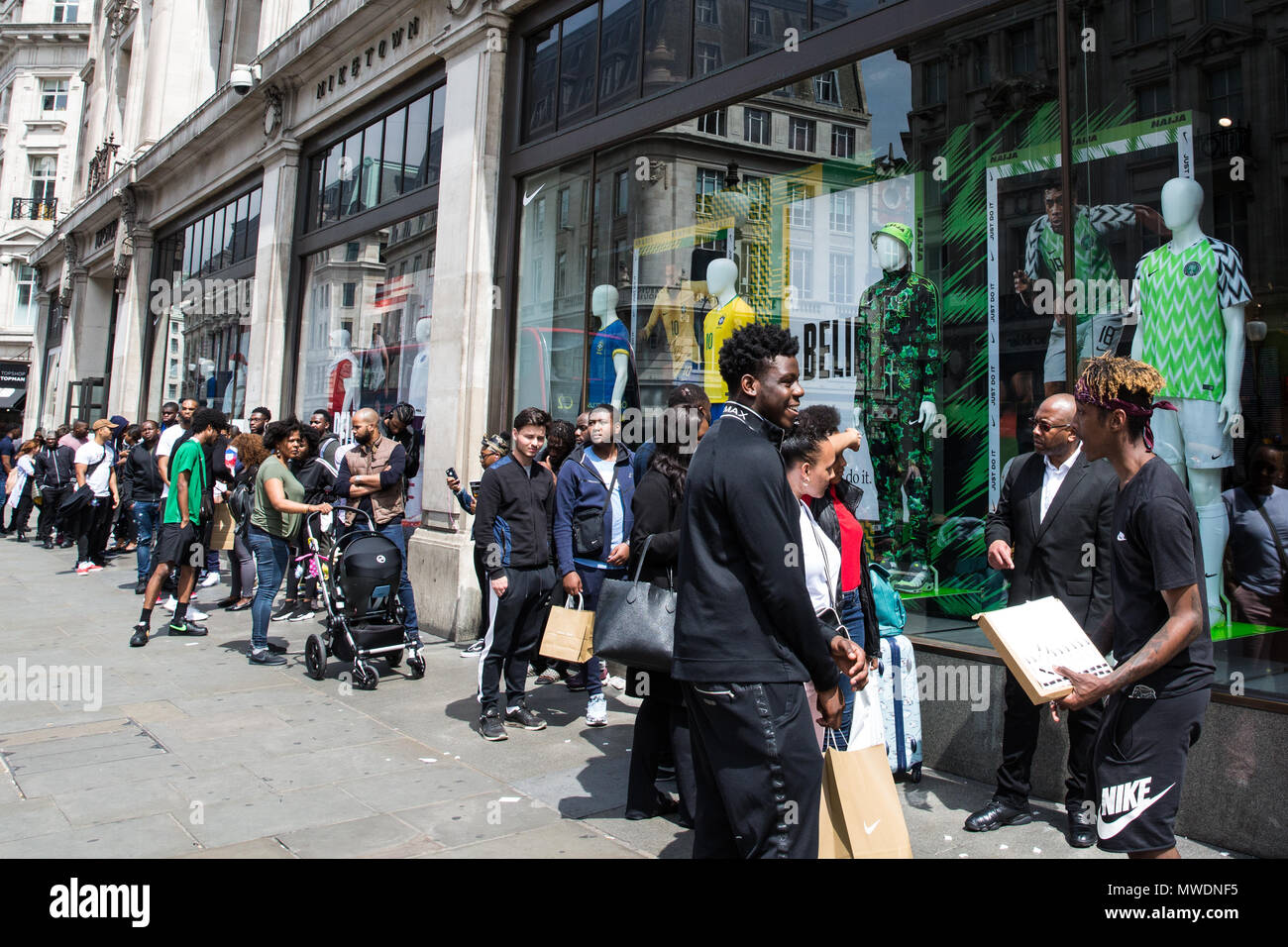 London, UK. 1st June, 2018. Fans of the Super Eagles, the Nigerian national  football team, queue outside Nike's flagship store in Oxford Street to buy  football kits for the forthcoming FIFA 2018