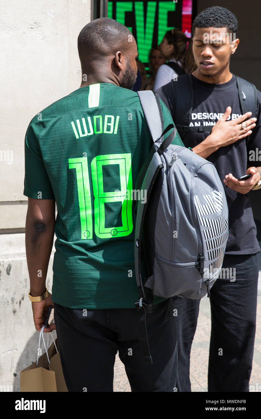 London, UK. 1st June, 2018. A man wears a Nigeria football shirt for the  forthcoming FIFA 2018 World Cup outside Nike's flagship store in Oxford  Street. Fans queued outside the store after
