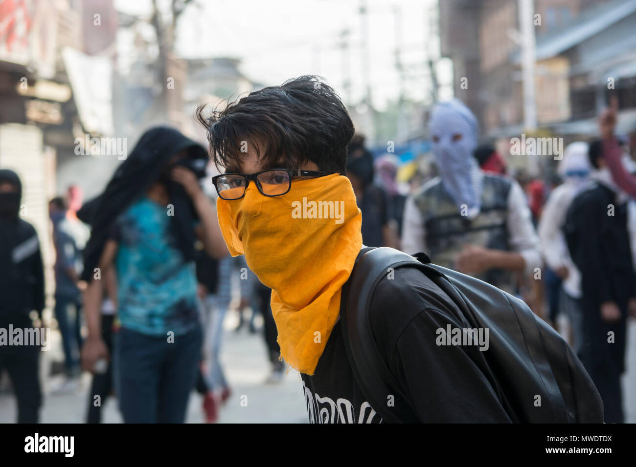 A masked protestor stands during the clashes in Srinagar. As hundreds of people held peaceful protest soon after the congregational prayers at the Jamia Masjid (Grand mosque), in Srinagar. Heavy clashes broke out when the speedy central reserve paramilitary force’s (CRPF) vehicle allegedly hit two youths during protest in Srinagar. Stock Photo