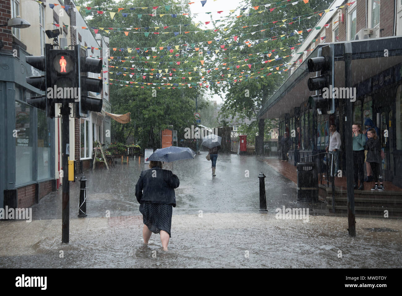 Shrewsbury, Shropshire, UK. 1st June 2018. A lady on a zebra crossing is caught out by the flash floods in Coleham, close to Shrewsbury town centre and the River Severn this afternoon. Within minutes, local shops were flooded and the road was eventually sealed off by the fire brigade. Credit: Richard Franklin/Alamy Live News Stock Photo