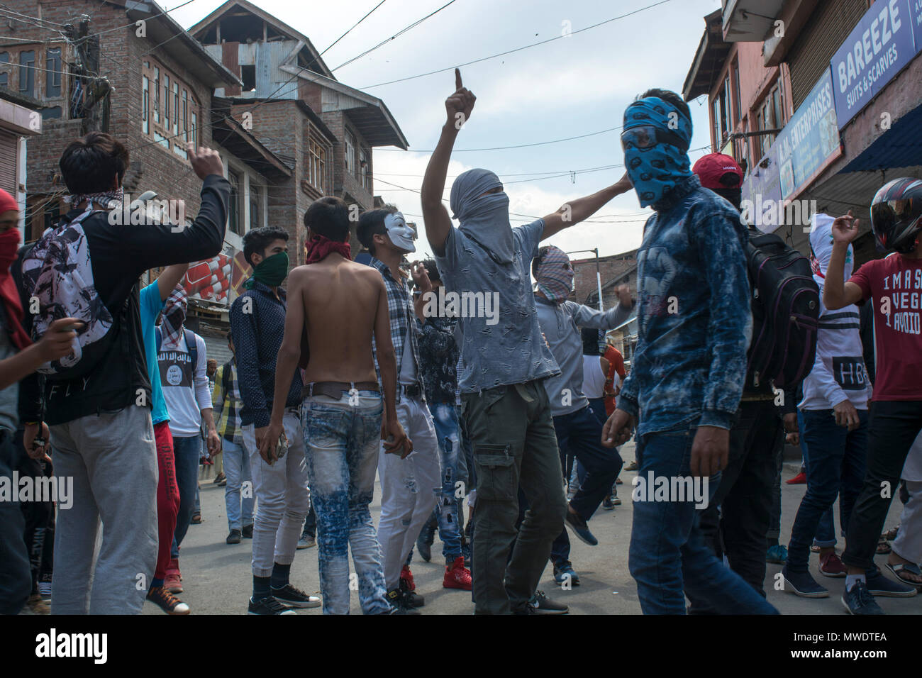 Kashmiri  masked protestors shout anti-Indian and pro freedom slogans as hundreds of people held peaceful protest soon after the congregational prayers at the Jamia Masjid (Grand mosque), in Srinagar. Heavy clashes broke out when the speedy central reserve paramilitary force’s (CRPF) vehicle allegedly hit two youths during protest in Srinagar. Stock Photo