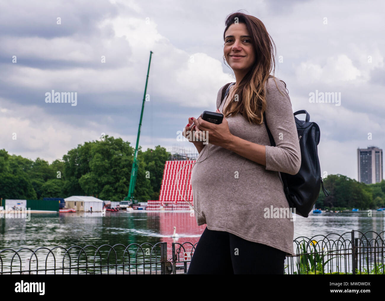 London, UK. 1st Jun, 2018. UK Weather: Cloudy day at Serpentine lake, Hyde Park.  A young mother-to-be smiles at the camera while enjoying a walk by the lake in Hyde Park, London, by the Princess Diana Memorial. Credit: Ernesto Rogata/Alamy Live News. Stock Photo