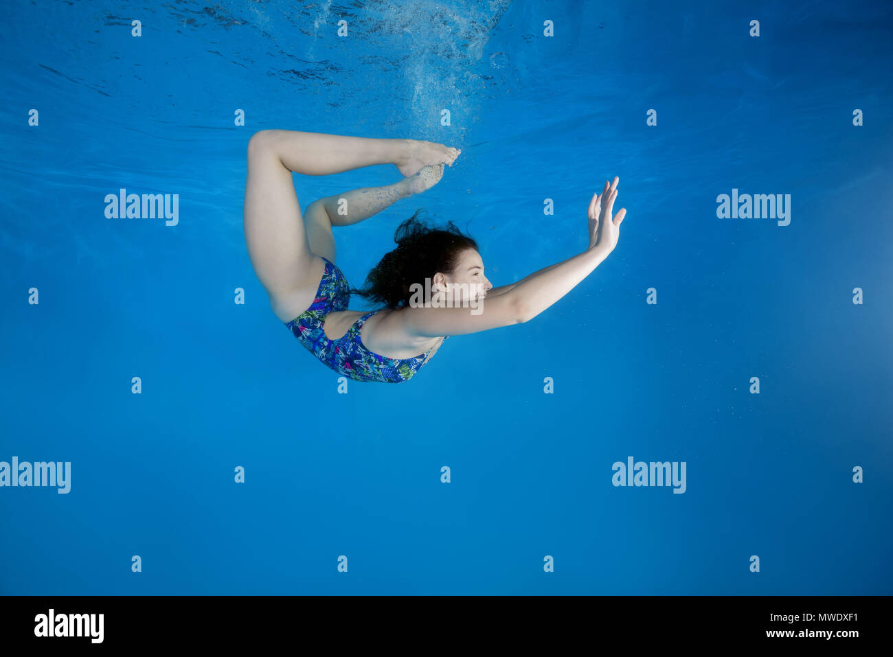 Odessa, Ukraine. 14th Aug, 2017. Girl curled into a wheel under water in the pool. Underwater acrobatics Credit: Andrey Nekrasov/ZUMA Wire/ZUMAPRESS.com/Alamy Live News Stock Photo