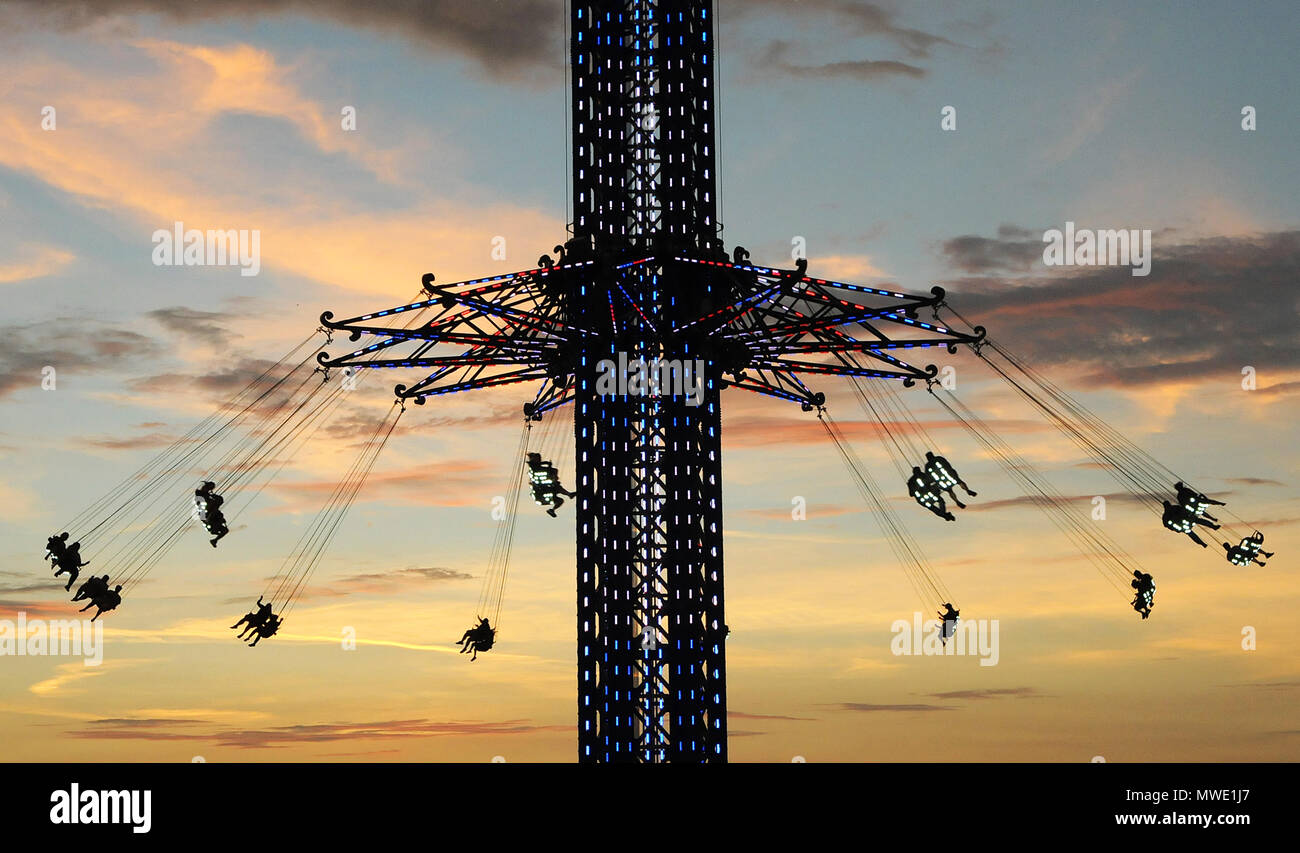 Florida, USA. 1st June 2018. People ride the Orlando Starflyer at sunset during its grand opening on June 1, 2018 in Orlando, Florida. The world's tallest swing ride, located in the International Drive tourist district and near the Orlando Eye observation wheel,  takes riders more than 400 feet in the air and swings them around at speeds topping 60 miles per hour. (Paul Hennessy/Alamy) Credit: Paul Hennessy/Alamy Live News Stock Photo