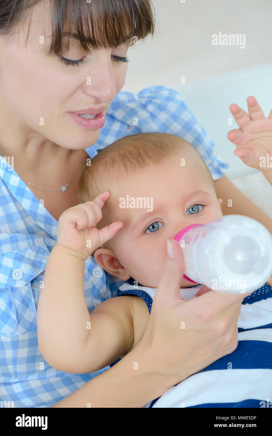 beautiful mother feeding baby