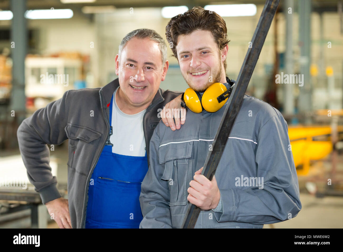 portrait of apprentice and engineer in factory Stock Photo - Alamy