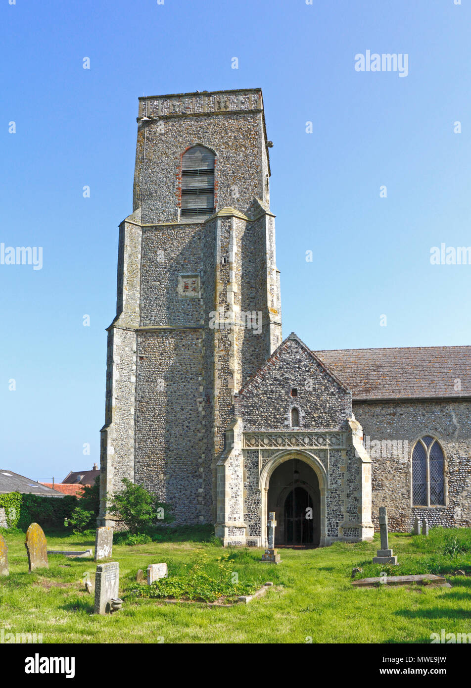 A view of the south porch and tower of the church of St John at Waxham, Norfolk, England, United Kingdom, Europe. Stock Photo