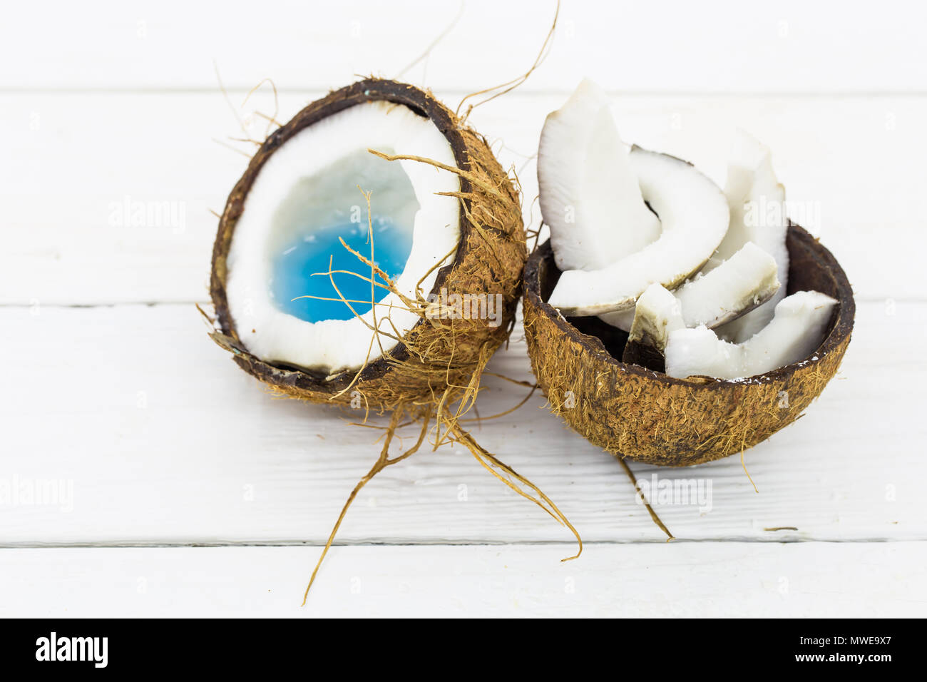 broken coconut, white wooden background, tasty and healthy Stock Photo Alamy