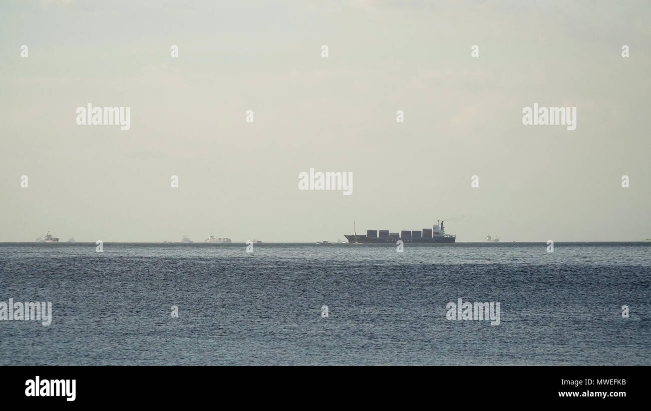 Cargo ship with containers floating on the sea. Cargo ships in the Bay