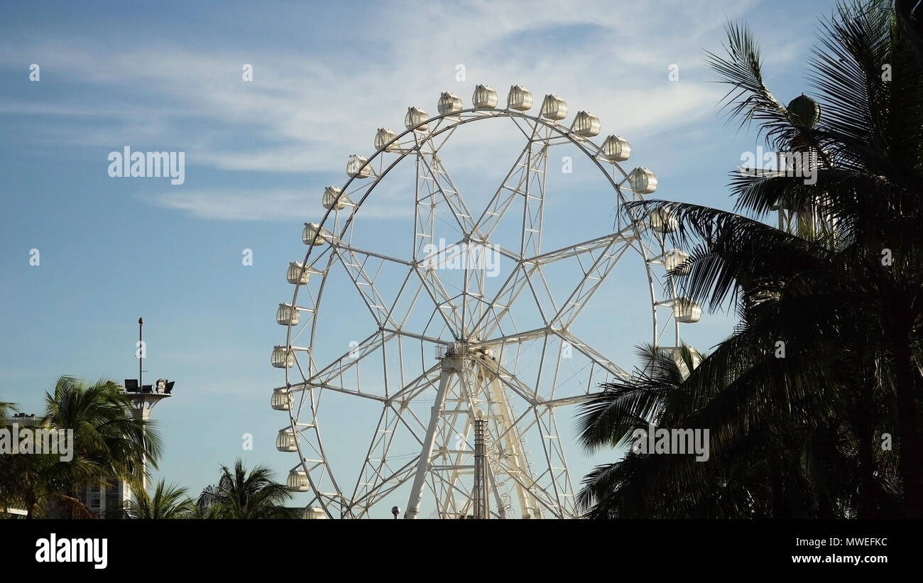 Ferris wheel in Manila, Mall of Asia. Ferris wheel against a blue sky ...